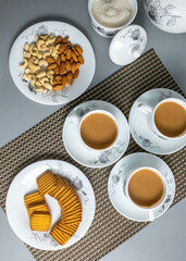 Tea time with Biscuits and dry fruits, White Plan Cashew, and Almonds.
seave in the white marble Tea set. 