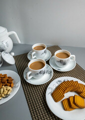 Tea time with Biscuits and dry fruits, White Plan Cashew, and Almonds.
seave in the white marble Tea set. 