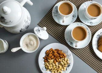 Tea time with Biscuits and dry fruits, White Plan Cashew, and Almonds.
seave in the white marble Tea set. 
