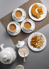 Tea time with Biscuits and dry fruits, White Plan Cashew, and Almonds.
seave in the white marble Tea set. 
