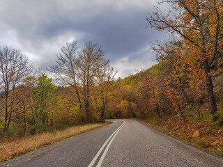 road street in winter and autumn in vrosina village greece rain fog