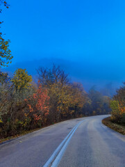 road street in winter and autumn in vrosina village greece rain fog