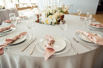 Luxurious restaurant. Luxurious interior, white tables, serving dishes and glasses for guests