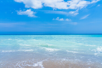 Turquoise clear water and blue sky in sunny weather on the beach a Melbourne beach, Florida