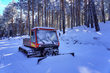 Snow-covered snowplow on the snowy forest path. Guadarrama Madrid.