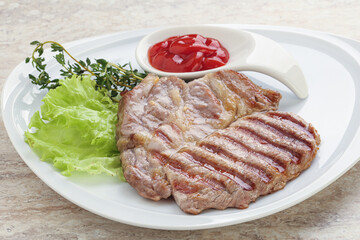 Grilled pork neck steak with ketchup