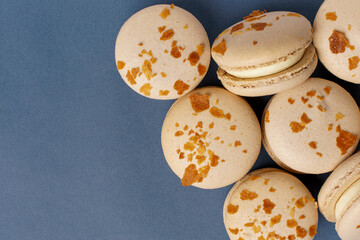 cakes macaron with waffle crumbs on a blue background