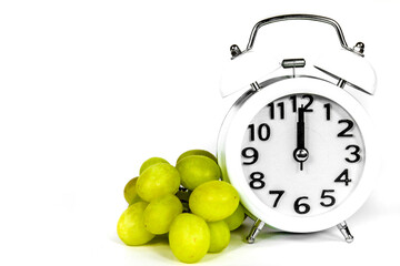 New Year at Midnight. Clock at twelve o'clock with grapes