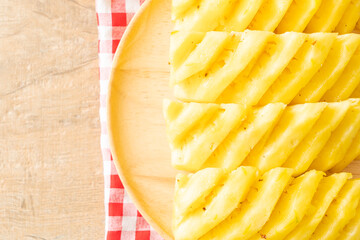 fresh pineapple sliced on plate