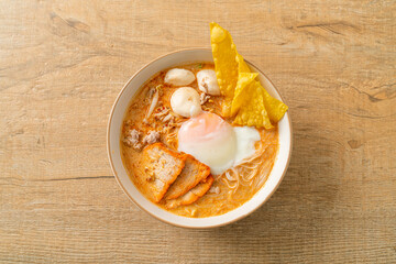 Rice vermicelli noodles with meatball, roasted pork and egg in spicy soup
