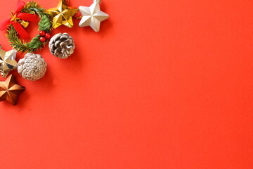 Christmas copy spaceframe for text with Christmas decoration on a red background. 