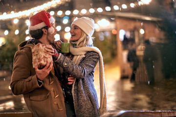 Man and woman outdoor in winter drinking hot tea and enjoy at romantic Christmas night