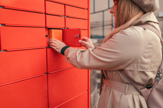 Pickup parcel. Post automat terminal and hand with parcel. Mail shipping concept