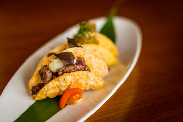 Japanese Wagyu Beef Mini Tacos with Chilli Ponzu on a white plate
