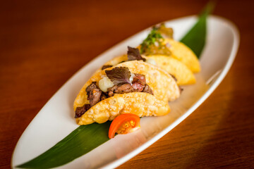 Japanese Wagyu Beef Mini Tacos with Chilli Ponzu on a white plate