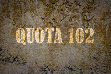 An old concrete wall with the superimposed writing in Italian: QUOTA 102. Retire before the expected age.