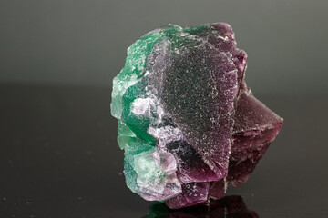 macro mineral stone green and purple fluorite on a black background