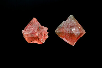 macro mineral stone pink fluorite on a black background