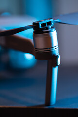 Obraz premium Close-up of the propellers and brushless motor of the Dji mavic 2 pro drone, diode fire. Repair and replacement of quadrocopter blades. Drone maintenance.