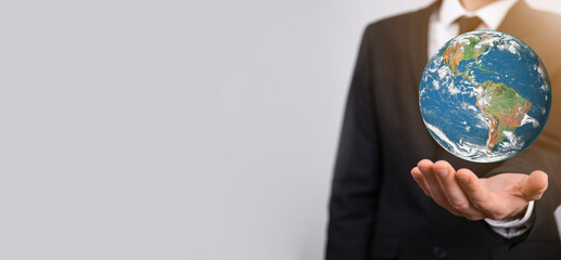 3D Earth planet globe in man, woman hand, hands on blue background. Environmental protection concept. Elements of this image furnished by NASA