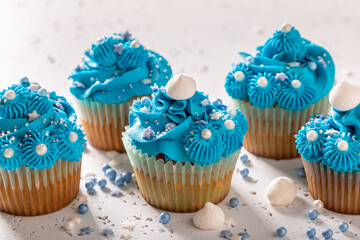 Sweet cupcakes made of blue cream for fat thursday.