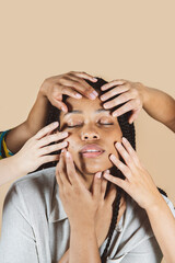 beauty african woman, with hands on her face beige background