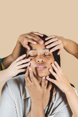 Obraz premium beauty african woman, with hands on her face beige background