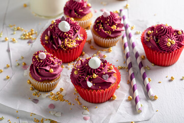 Delicious red cupcakes made of sprinkles and whipped cream.