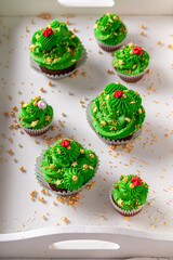 Beautiful green cupcakes made of whipped cream and sprinkles.