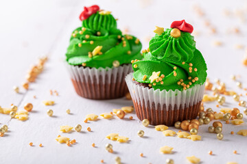 Homemade green cupcakes with sprinkles and made for the Christmas.