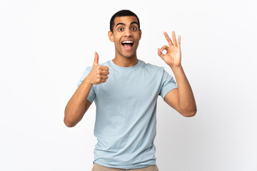Fototapeta premium African American man over isolated white background showing ok sign and thumb up gesture