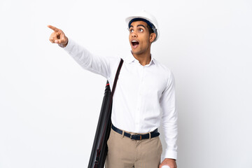African American architect man with helmet and holding blueprints over isolated white background _ pointing away