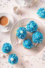 Cute blue cupcakes with flower shaped cream.