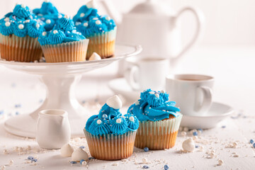 Sweet blue cupcakes with cream and sprinkles for fat thursday.