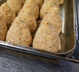 preparation of typical sicilian food called arancino