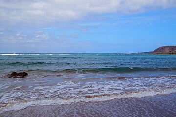 Fototapeta premium Beach in the Canary Islands. Surf waves and endless horizon. Sky and clouds.