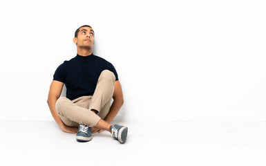 Fototapeta premium African American man sitting on the floor and looking up