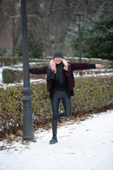 Fototapeta premium happy woman in the park full of snow in the wintertime