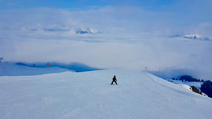Child skiing on empty slopes in Montafon, Vorarlberg, Austria.
