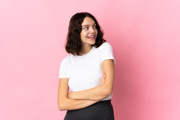 Teenager Ukrainian girl isolated on pink background happy and smiling