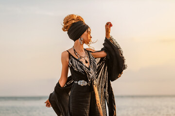 beautiful young stylish woman posing at sunset
