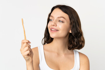 Teenager Ukrainian girl isolated on white background with a toothbrush