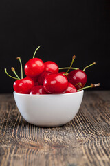 red ripe sweet cherries on a wooden table