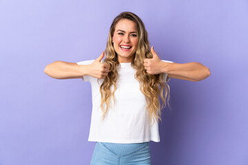 Fototapeta na wymiar Young Brazilian woman isolated on purple background giving a thumbs up gesture