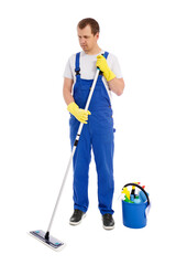 full length portrait of man cleaner in blue uniform cleaning floor with mop and bucket with cleaning equipment isolated on white background