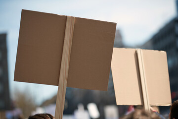 Protesters holding placards and signs on the streets.