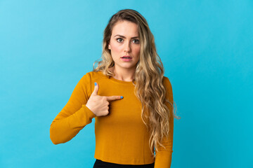 Young Brazilian woman isolated on blue background pointing to oneself