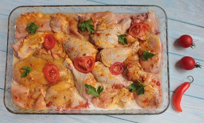 Raw chicken meat, tomatoes and spices, top view.