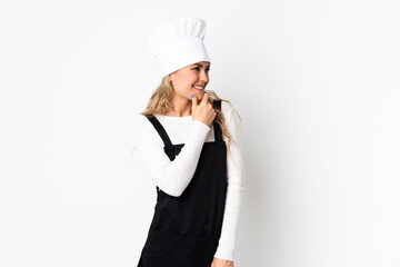 Young Brazilian chef woman isolated on white background looking to the side and smiling