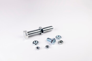 Bolts and nuts on a white background. Small and large bolts. Small and large nuts. Size problem.